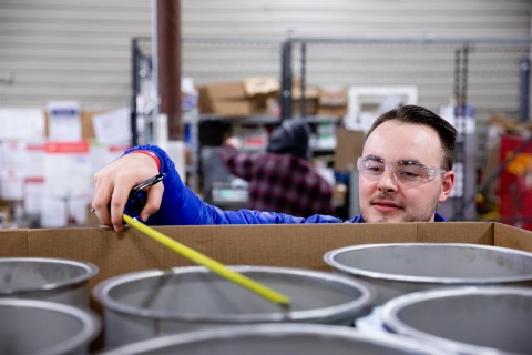 A US Duct employee measures ductwork as part of a quality assurance process before it gets shipped to a customer.